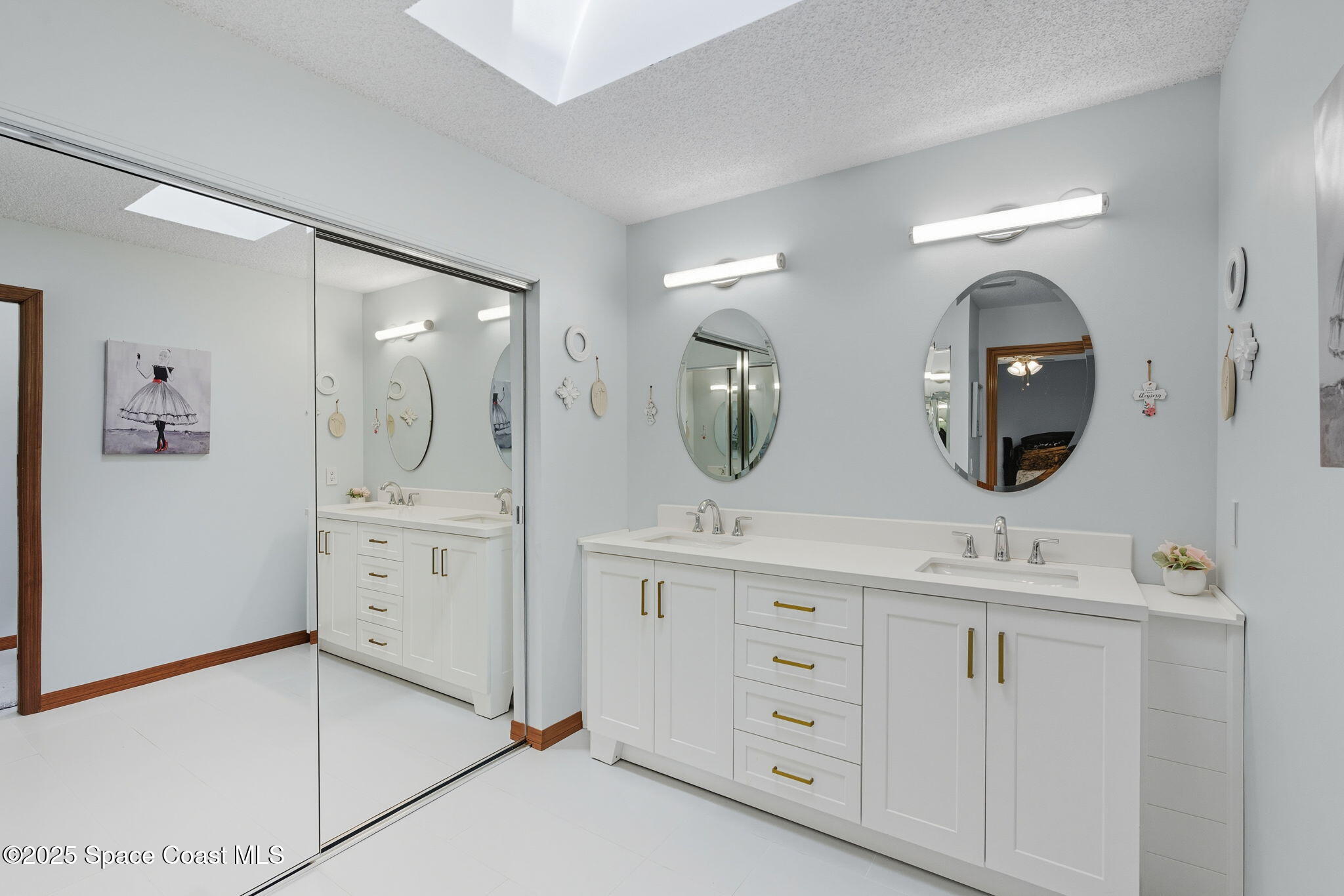 710 Spring Valley Drive Melbourne, FL 32940 - Photo 19 of 30 a bathroom with a double vanity sink and a mirror
