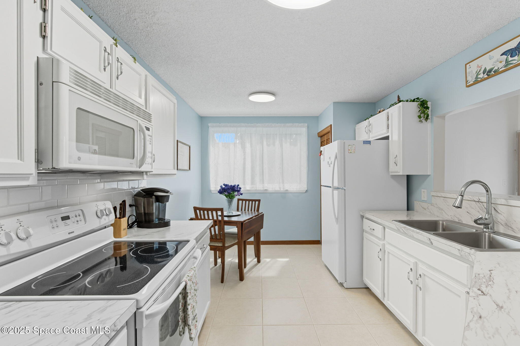 710 Spring Valley Drive Melbourne, FL 32940 - Photo 2 of 30 a kitchen that has a sink cabinets counter space and appliances