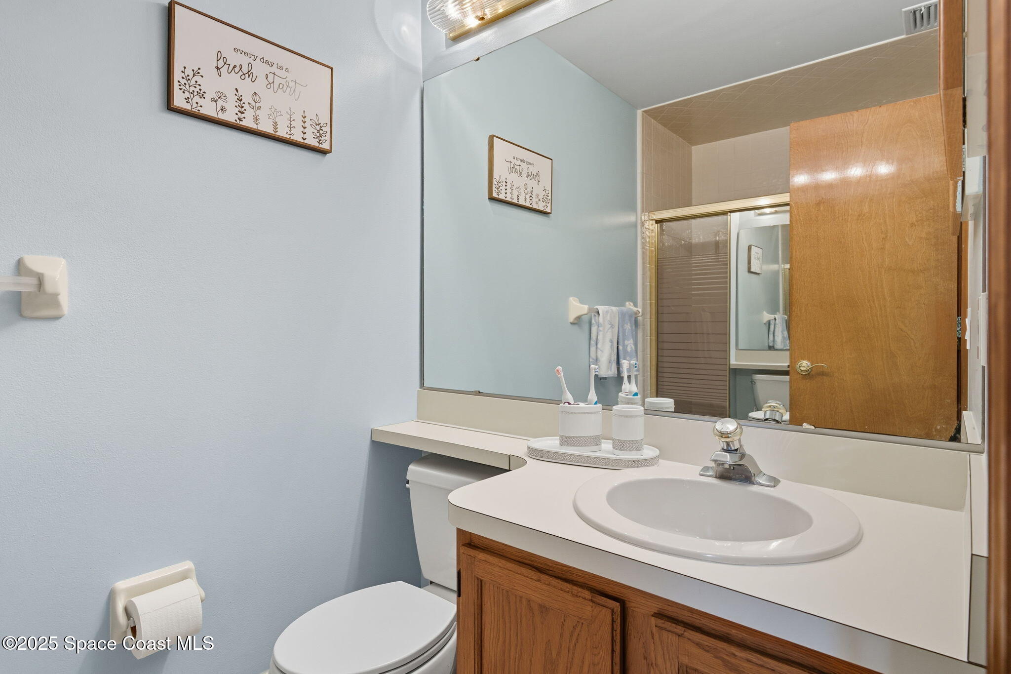 710 Spring Valley Drive Melbourne, FL 32940 - Photo 21 of 30 a bathroom with a toilet sink and mirror
