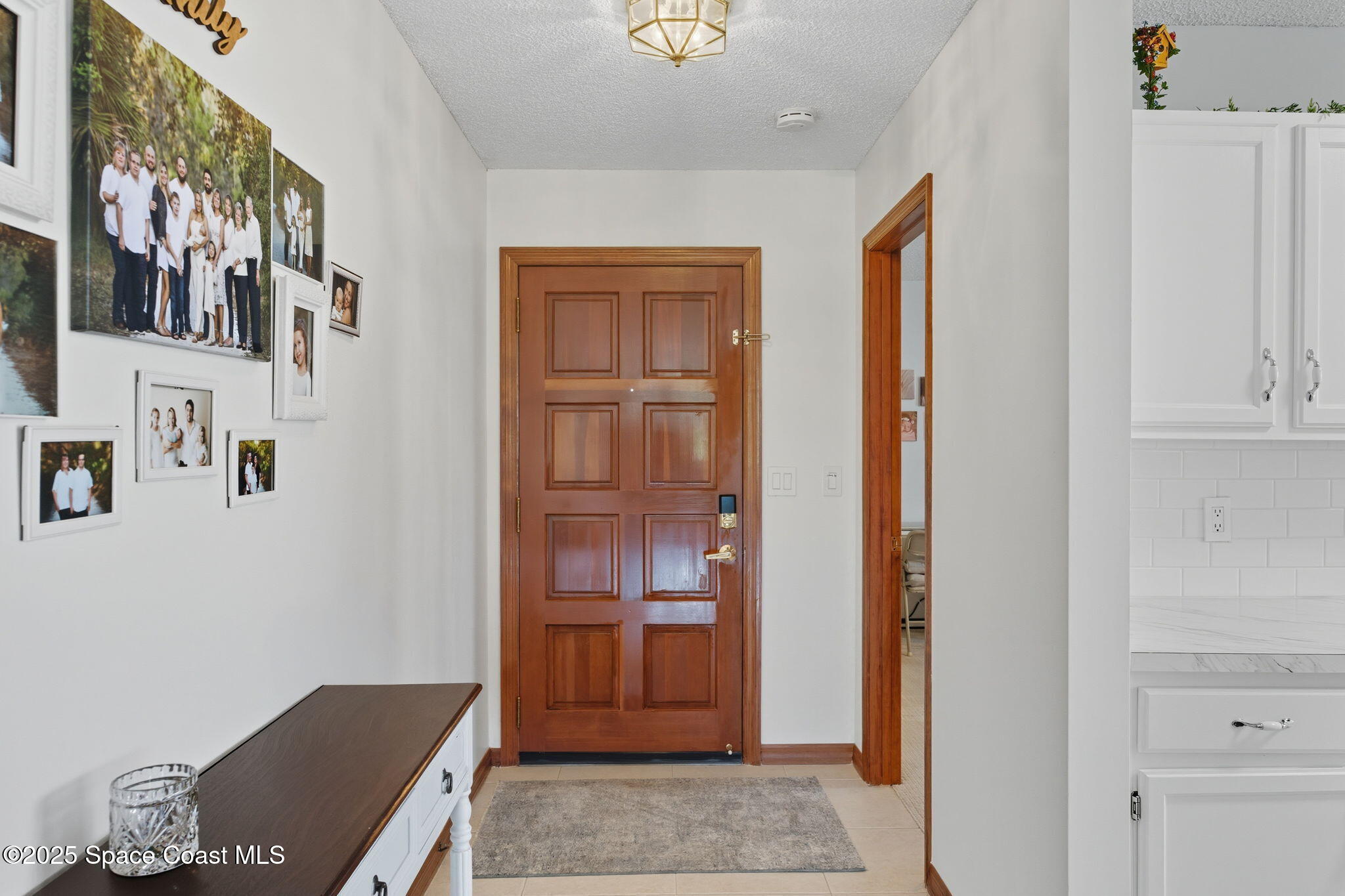 710 Spring Valley Drive Melbourne, FL 32940 - Photo 9 of 30 a view of a hallway with elevator and cabinet