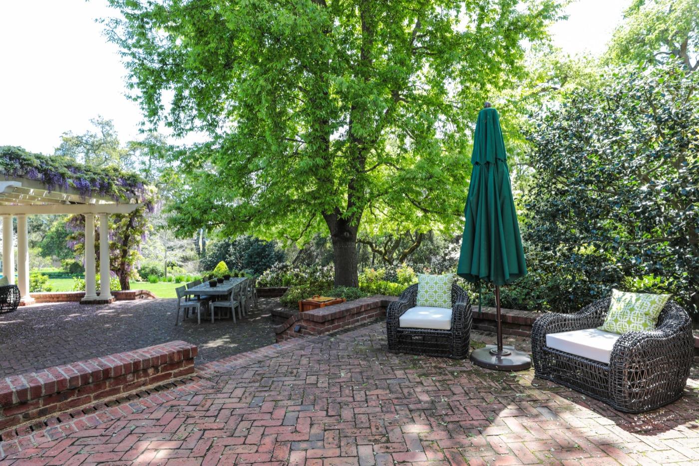 218 Family Farm Road Woodside, CA 94062 - Photo 16 of 19 a view of a patio with couches table and chairs and potted plants