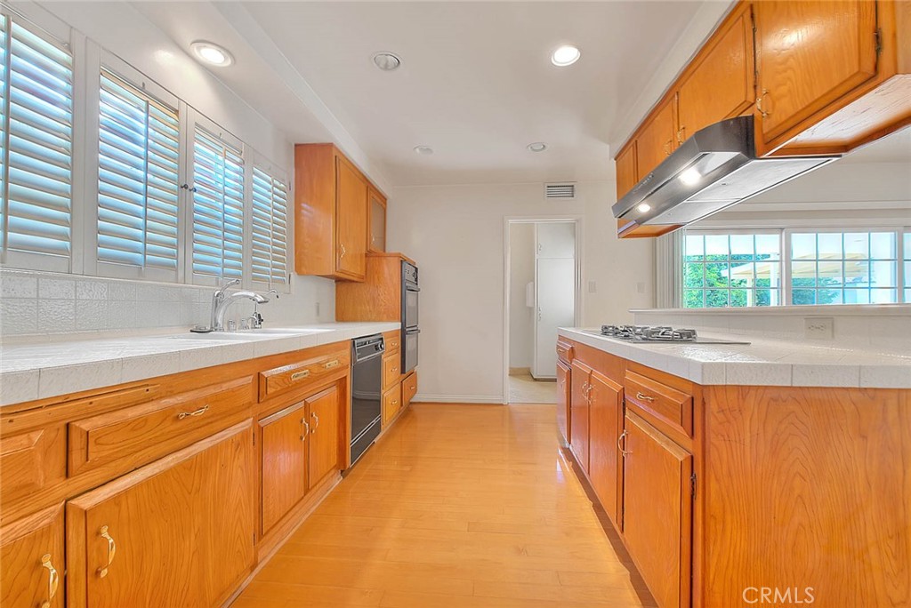 620 North 5th Street Montebello, CA 90640 - Photo 17 of 68 a large kitchen with stainless steel appliances a sink and cabinets