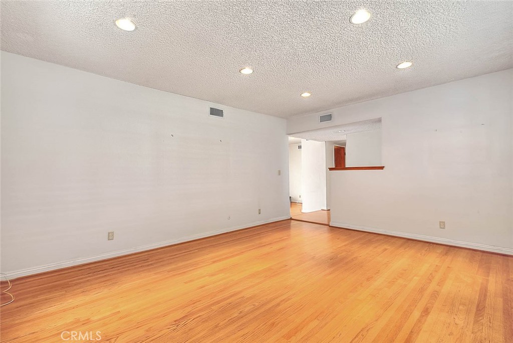 620 North 5th Street Montebello, CA 90640 - Photo 7 of 68 an empty room with wooden floor and windows