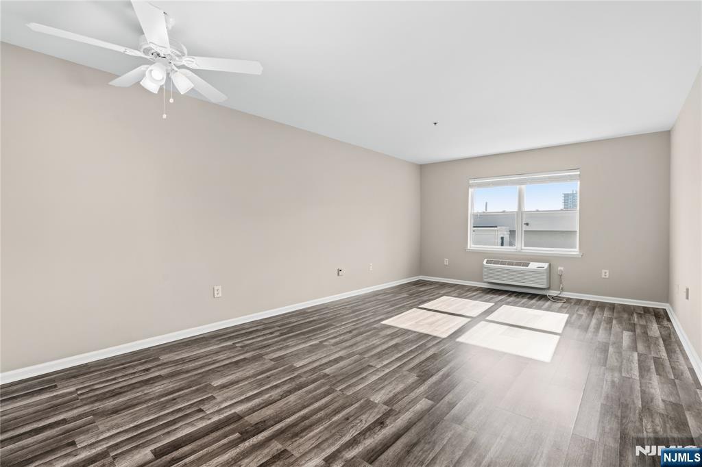 905 River Road, Unit 210 Edgewater, NJ 07020 - Photo 6 of 35 wooden floor in an empty room with a window
