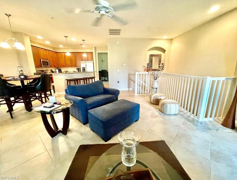 9050 Capistrano Street North, Unit 4102 Naples, FL 34113 - Photo 8 of 31 a living room with furniture and a table