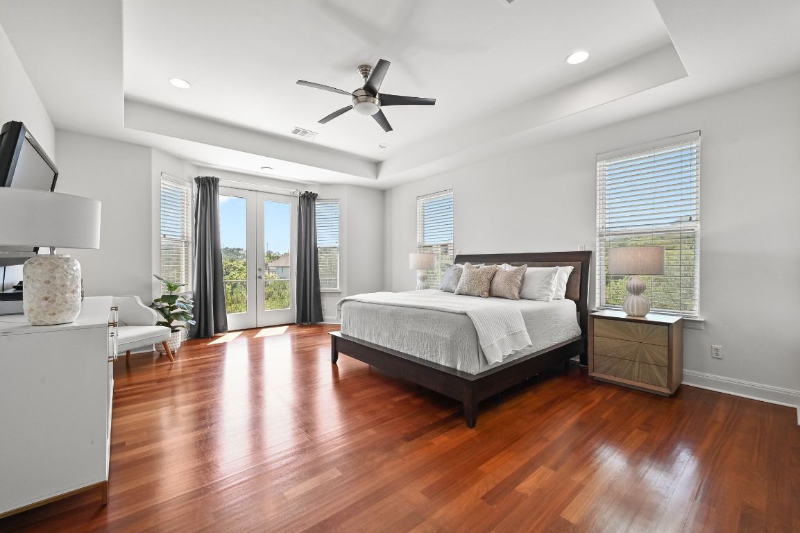 405 Barrett Lane, Unit 1 Austin, TX 78733 - Photo 13 of 26 a bedroom with a bed and wooden floor