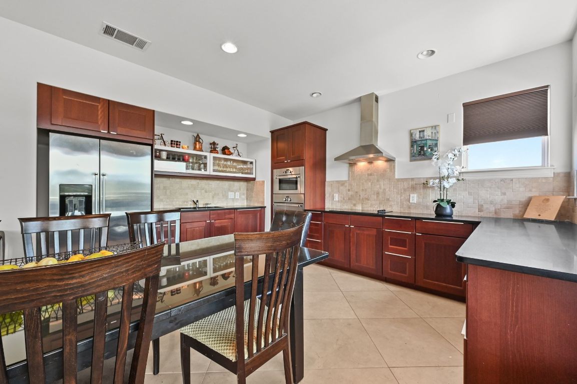 405 Barrett Lane, Unit 1 Austin, TX 78733 - Photo 18 of 26 a kitchen with stainless steel appliances granite countertop a stove a sink and a microwave