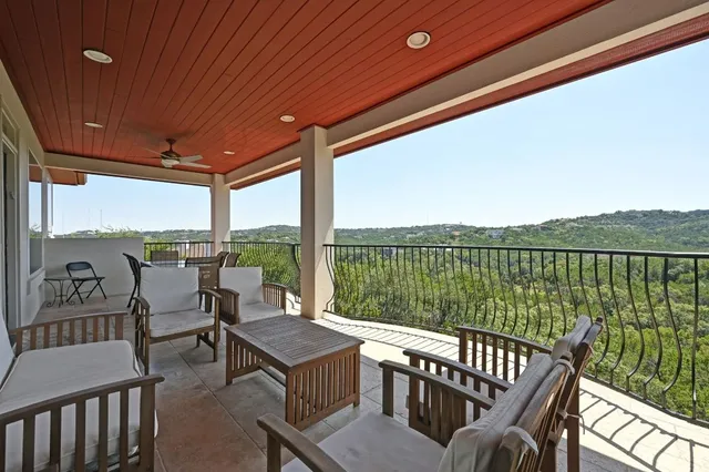 a view of a balcony with lake view and wooden floor