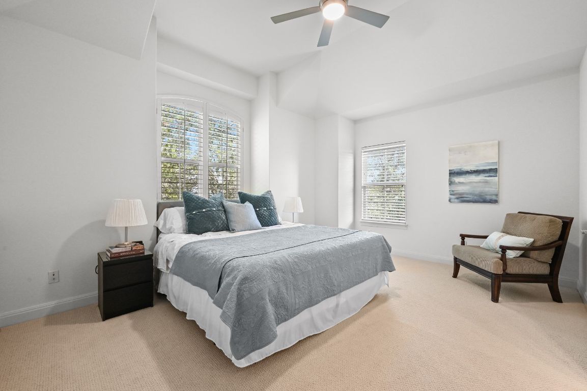 405 Barrett Lane, Unit 1 Austin, TX 78733 - Photo 25 of 26 a bedroom with a bed and a chandelier