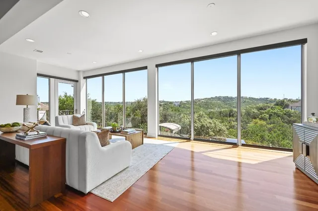 a living room with hardwood floor and furniture