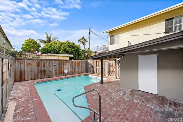 a backyard of a house with wooden floor and fence