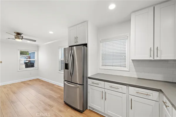 a kitchen with a refrigerator and window