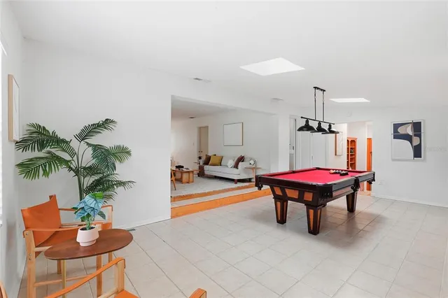 a view of a livingroom with furniture and a potted plant