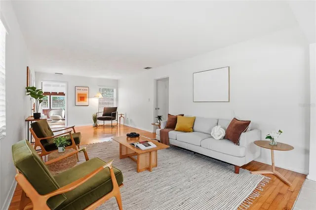 a living room with furniture rug and window
