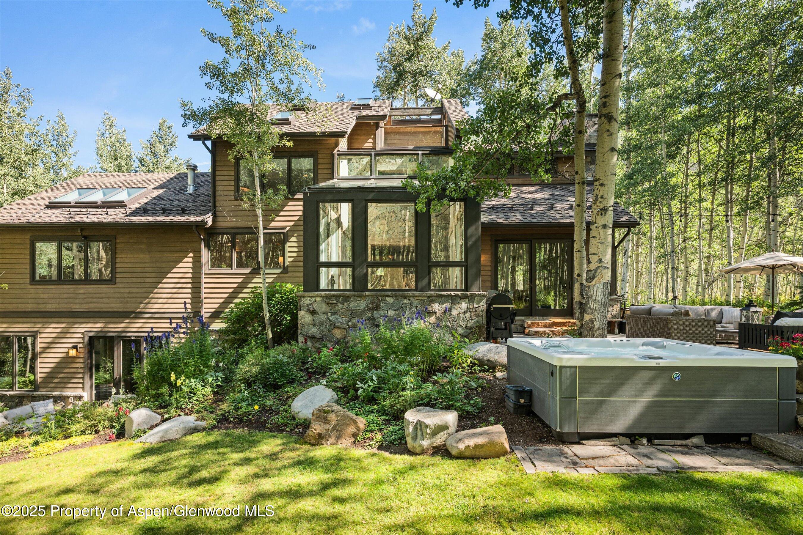 9555 Castle Creek Road Aspen, CO 81612 - Photo 4 of 42 a view of a patio with table and chairs and potted plants