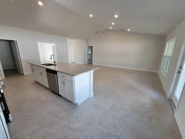 a kitchen with stainless steel appliances granite countertop a stove and a refrigerator