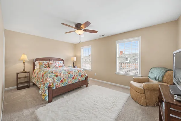 a bedroom with a bed couch and window
