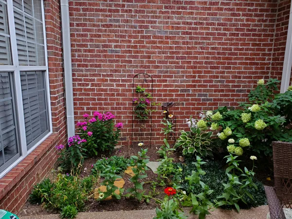 a view of a house with a flower garden