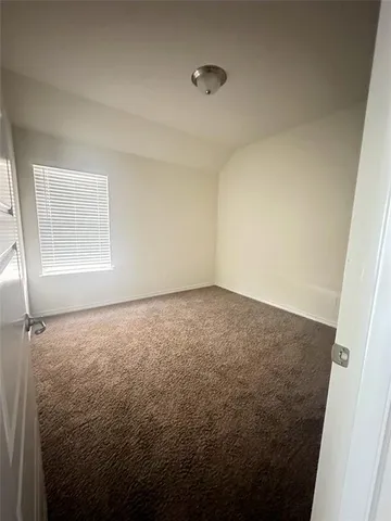 an empty room with a empty space and windows