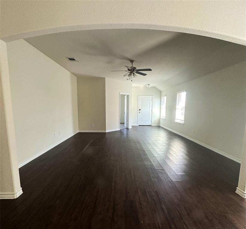 223 Garden Grove Drive Waxahachie, TX 75165 - Photo 2 of 24 an empty room with wooden floor and windows