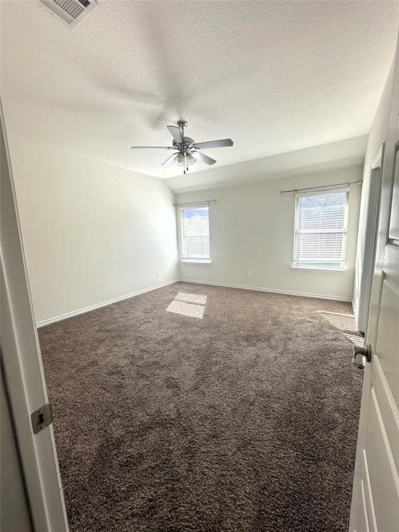 223 Garden Grove Drive Waxahachie, TX 75165 - Photo 7 of 24 an empty room with windows and fan