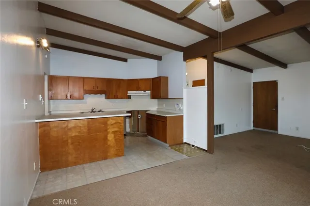 a large kitchen with stainless steel appliances granite countertop a sink and cabinets