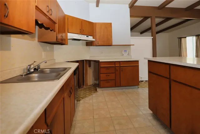 a kitchen with stainless steel appliances granite countertop a sink stove and cabinets