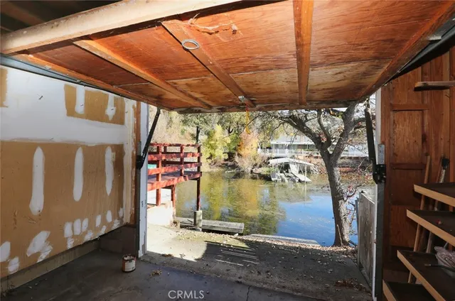 an aerial view of a white building with floor to ceiling window and outdoor kitchen