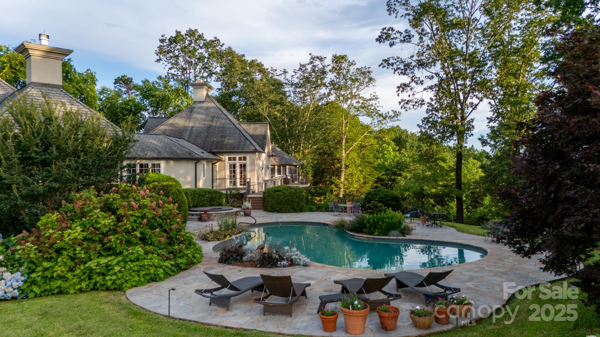 650 Golf Course Road Tryon, NC 28782 - Photo 12 of 48 a view of a house with garden space and a patio