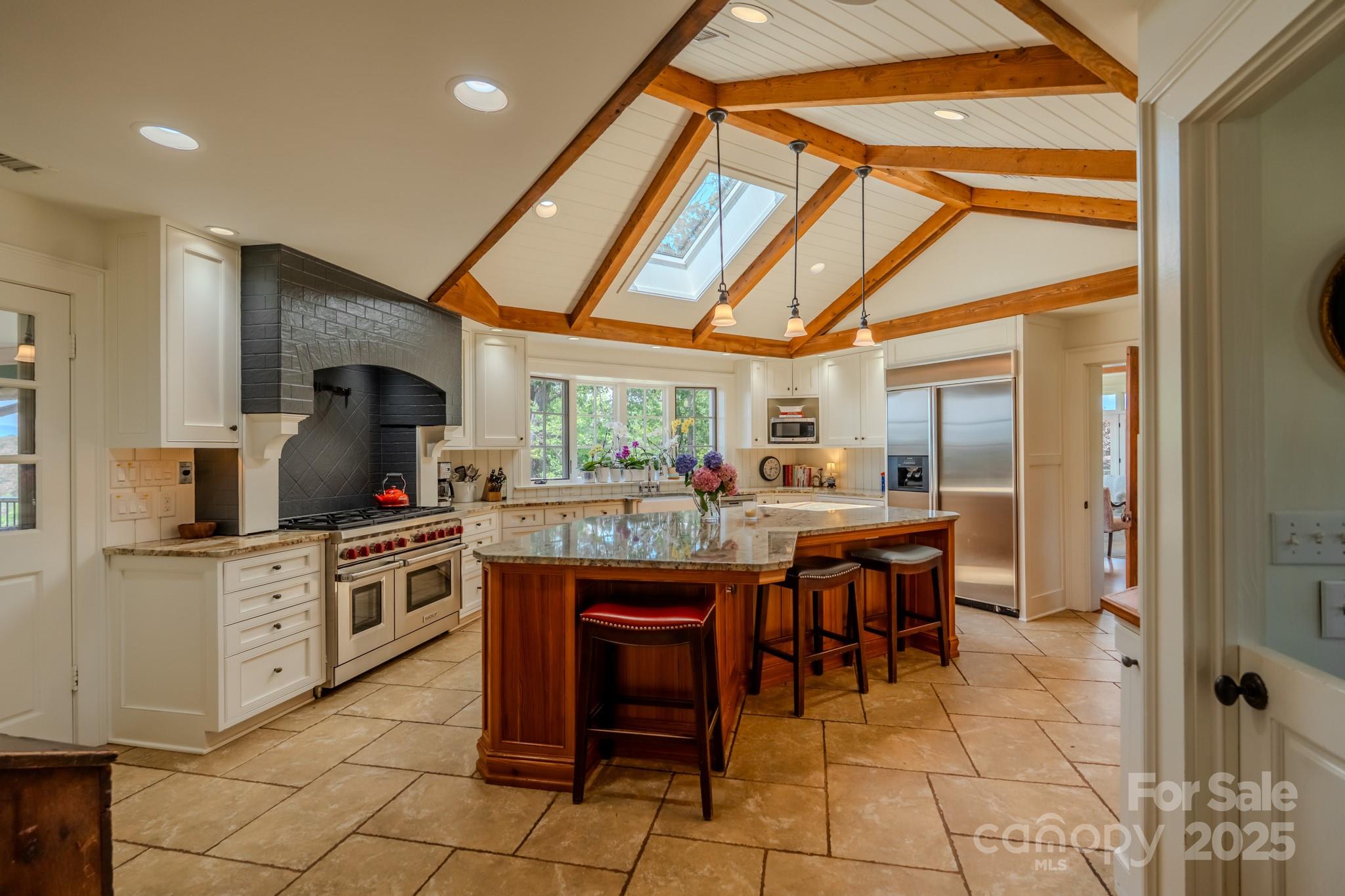 650 Golf Course Road Tryon, NC 28782 - Photo 21 of 48 a kitchen with a sink and chairs