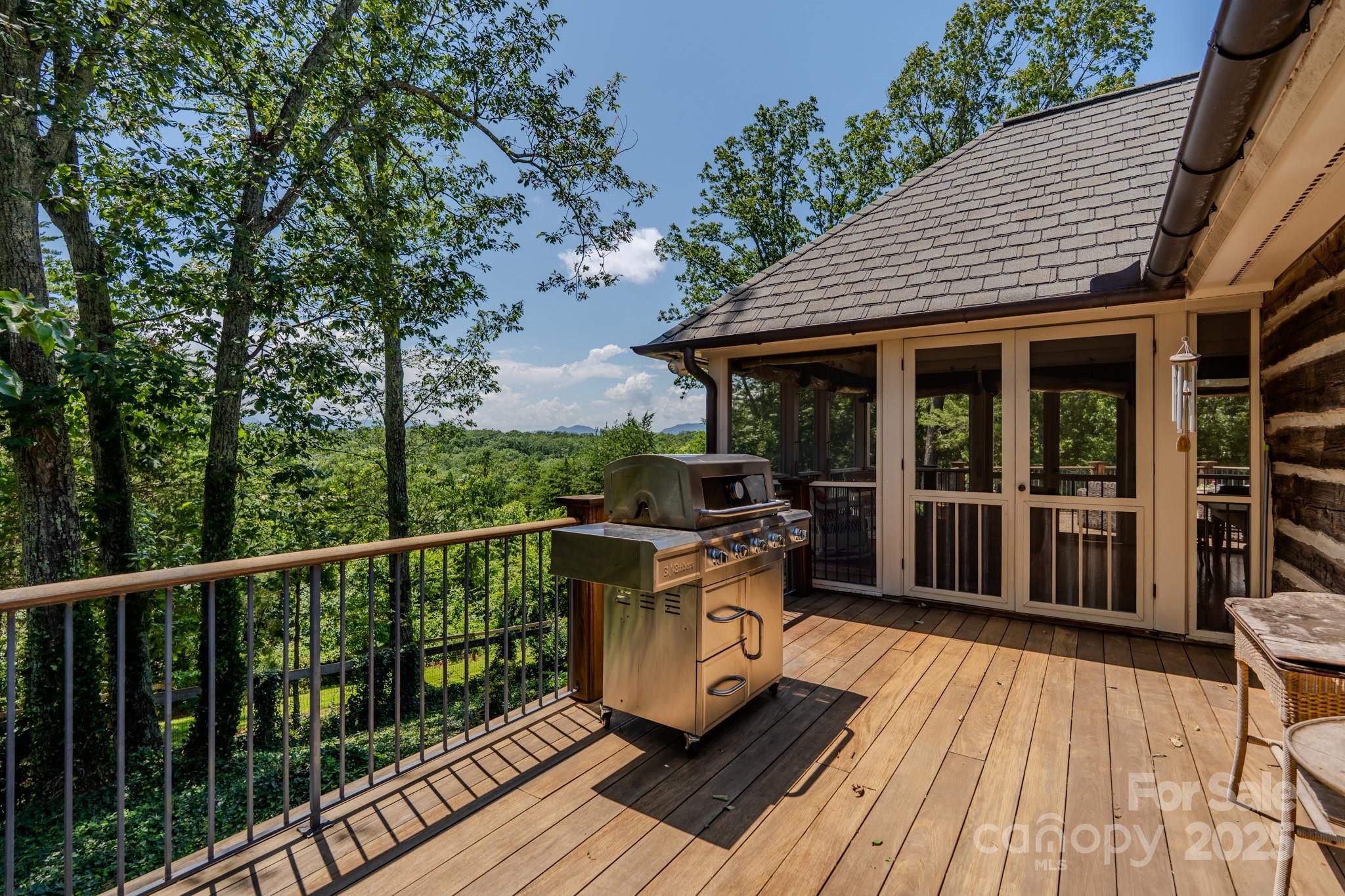 650 Golf Course Road Tryon, NC 28782 - Photo 36 of 48 a view of a patio with table and chairs wooden floor and fence