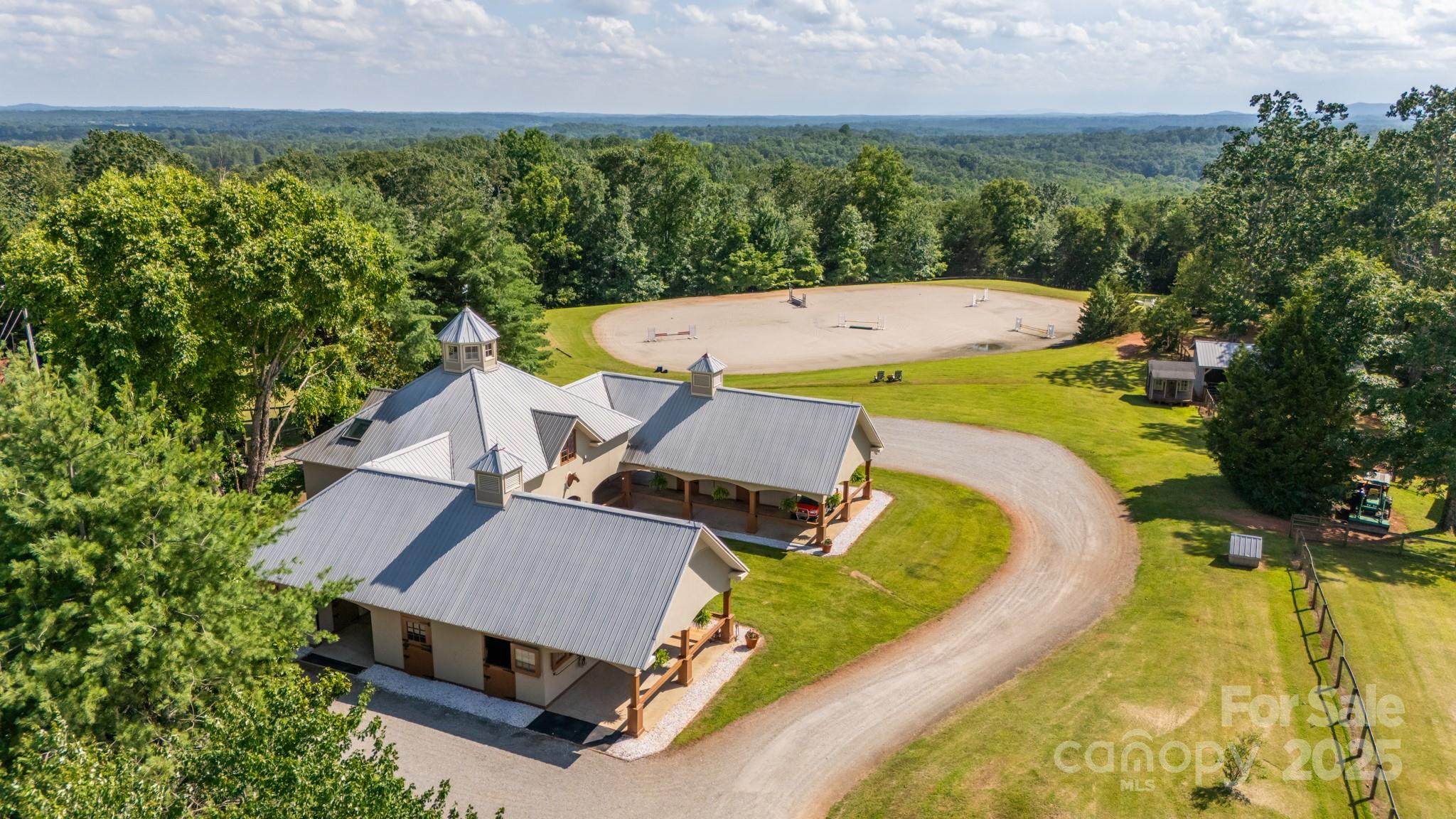 650 Golf Course Road Tryon, NC 28782 - Photo 6 of 48 an aerial view of a house with swimming pool and large trees