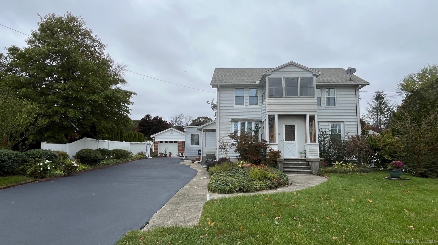 a front view of a house with a yard and potted plants