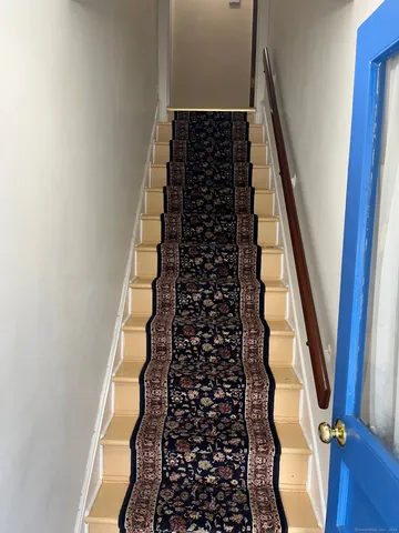 a view of kitchen with furniture and a refrigerator