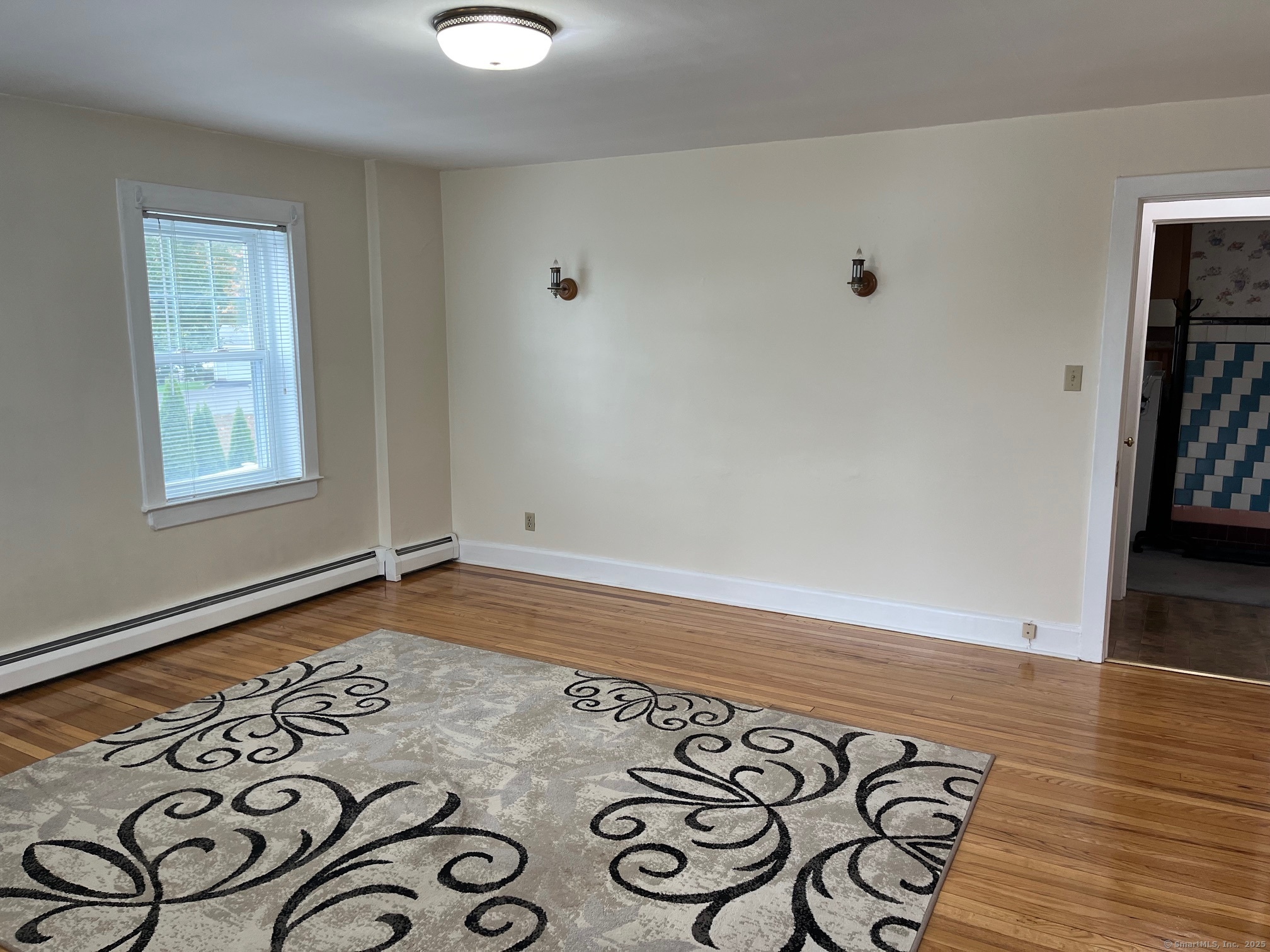 18 Coe Lane Ansonia, CT 06401 - Photo 6 of 12 an empty room with wooden floor and windows