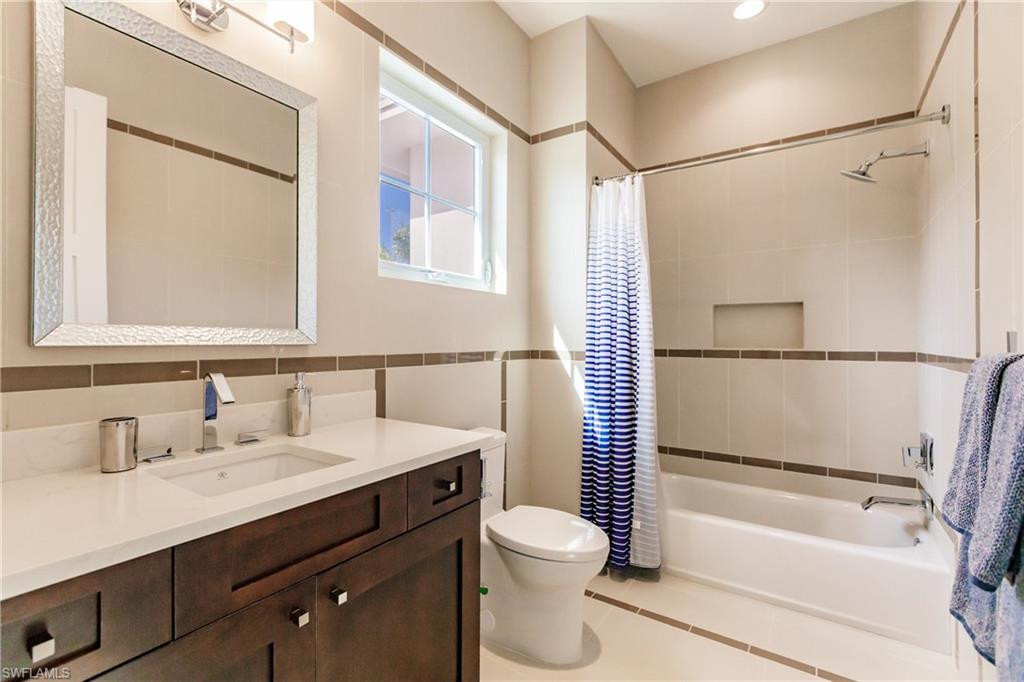 9214 Mercato Way Naples, FL 34108 - Photo 28 of 41 a bathroom with a sink a toilet and a bathtub