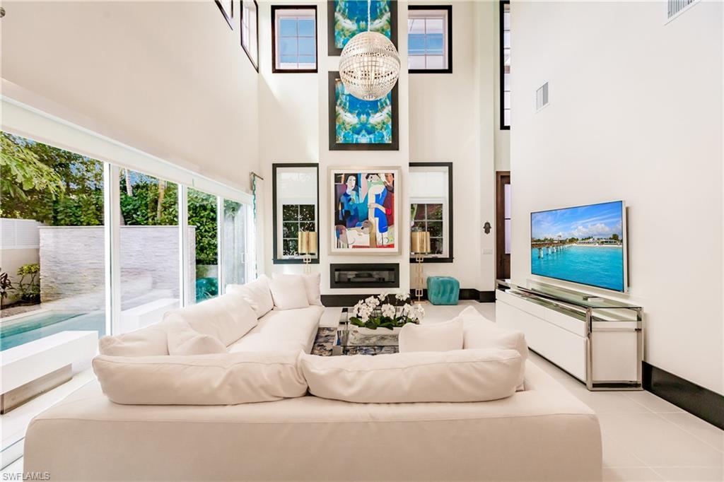 9214 Mercato Way Naples, FL 34108 - Photo 8 of 41 a living room with furniture and a flat screen tv