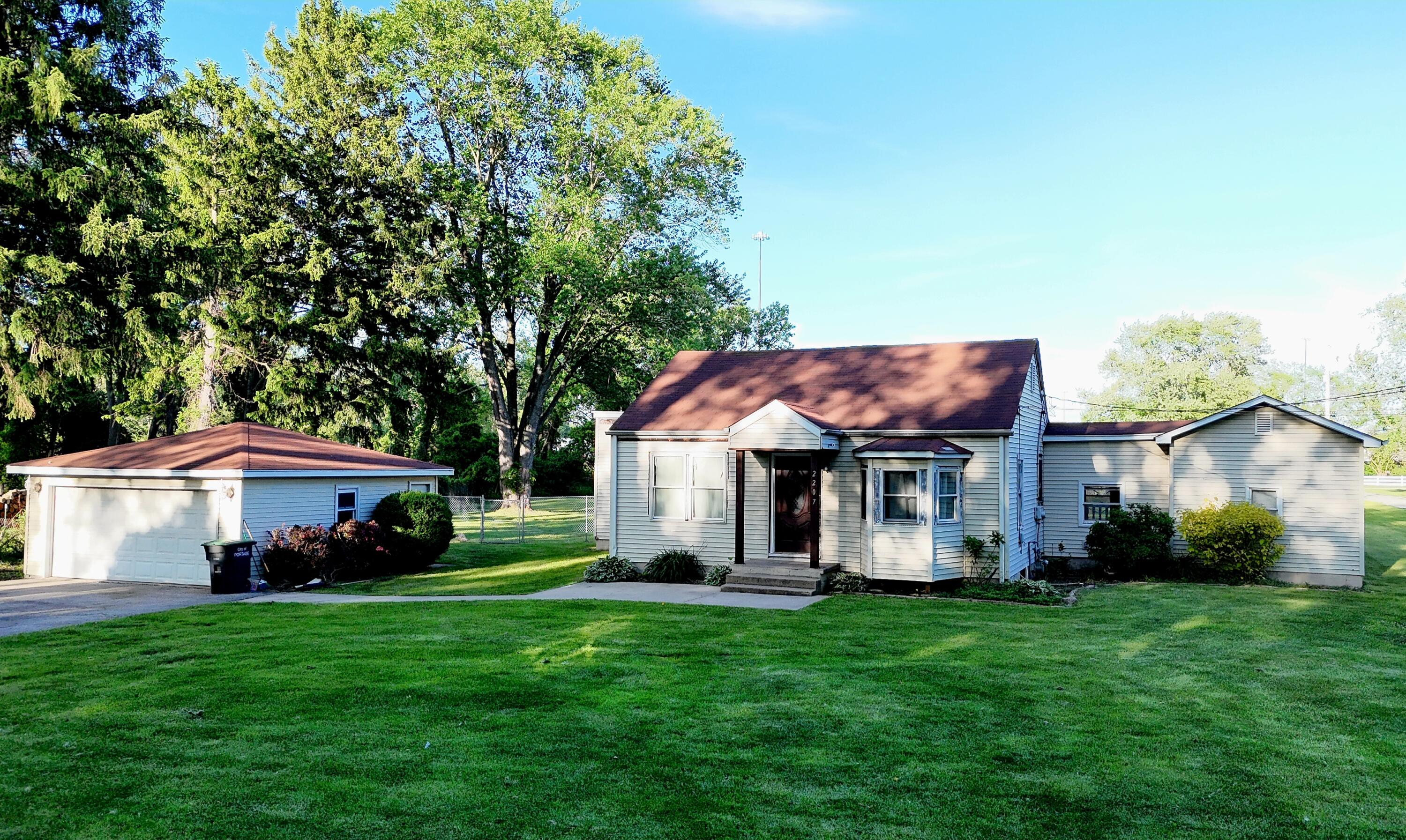 2207 North County Line Road Portage, IN 46368 - Photo 1 of 16 a front view of a house with a garden