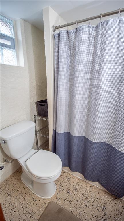 136 Clarks Pike Road Creighton, PA 15030 - Photo 22 of 27 a white toilet sitting next to a shower curtain