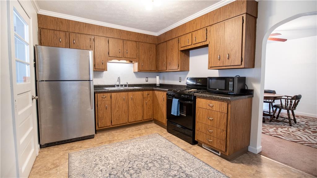 136 Clarks Pike Road Creighton, PA 15030 - Photo 9 of 27 a kitchen with stainless steel appliances granite countertop a refrigerator a stove a sink and a microwave