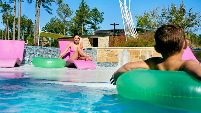 a room with gym equipment and large windows