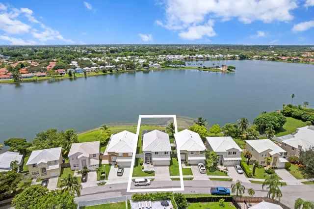an aerial view of residential building with outdoor space and lake view