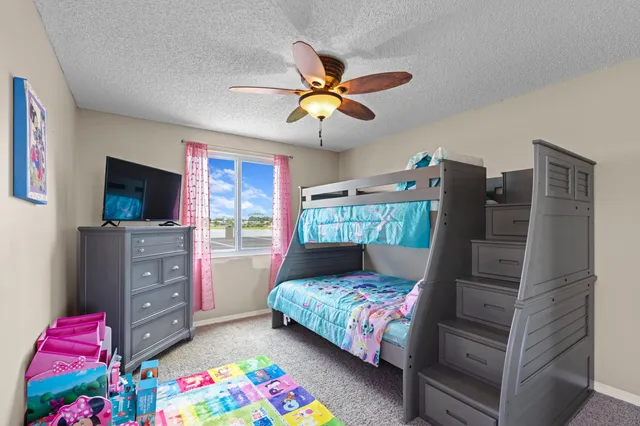 a bedroom with a bed closet and flat tv screen