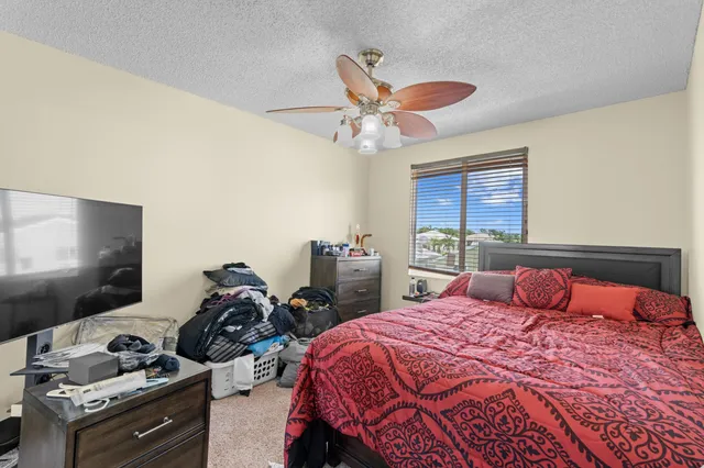 a bedroom with two beds and a flat screen tv