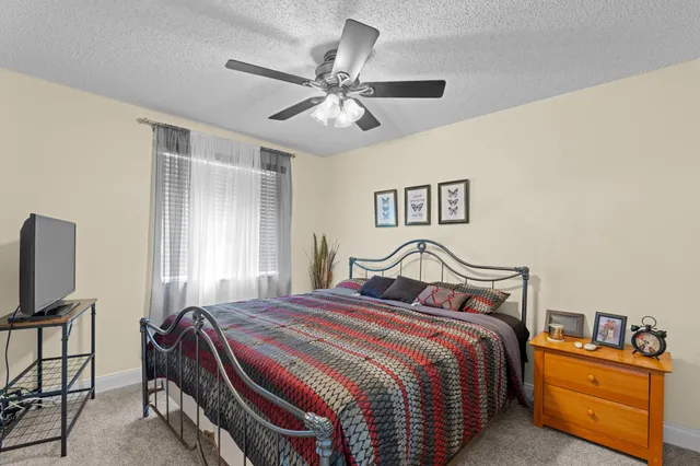 a bedroom with bed and window