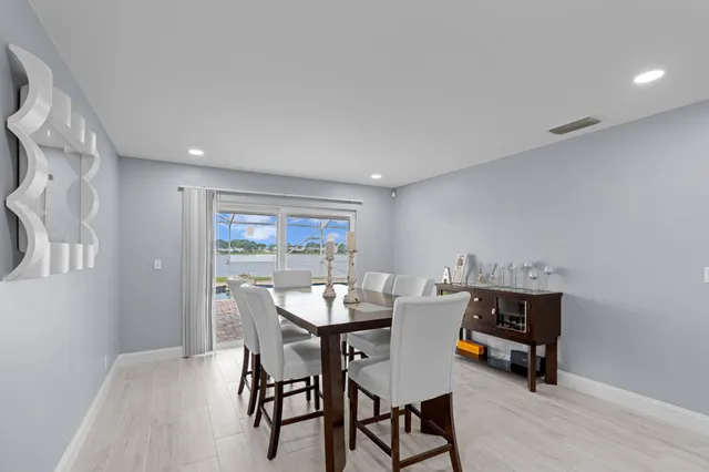 a dining room with a table and chairs
