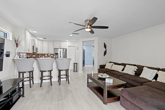 a living room with furniture and kitchen view