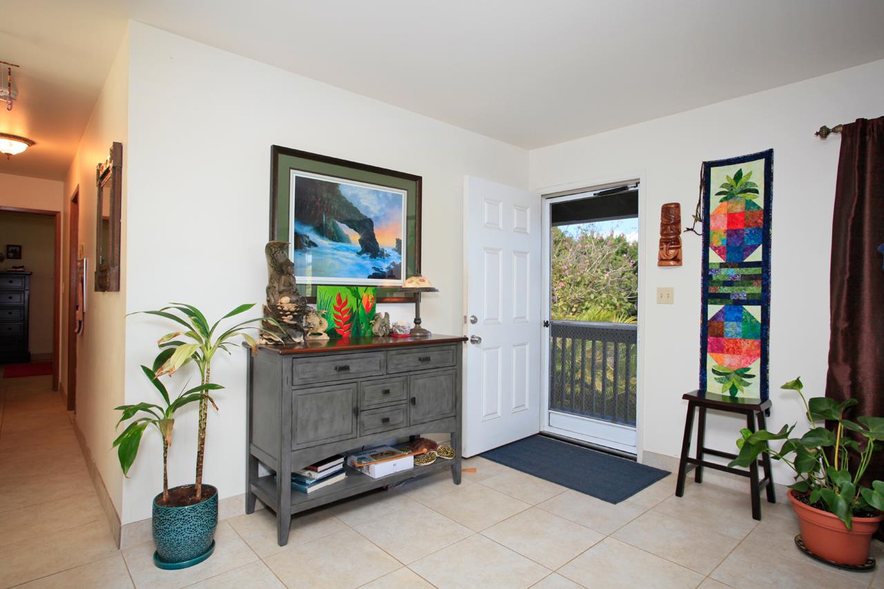 2811 Kokomo Road Haiku, HI 96708 - Photo 14 of 30 a living room with furniture and a potted plant