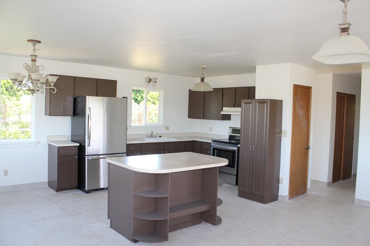 2811 Kokomo Road Haiku, HI 96708 - Photo 5 of 30 a kitchen with stainless steel appliances granite countertop a refrigerator a sink and a stove