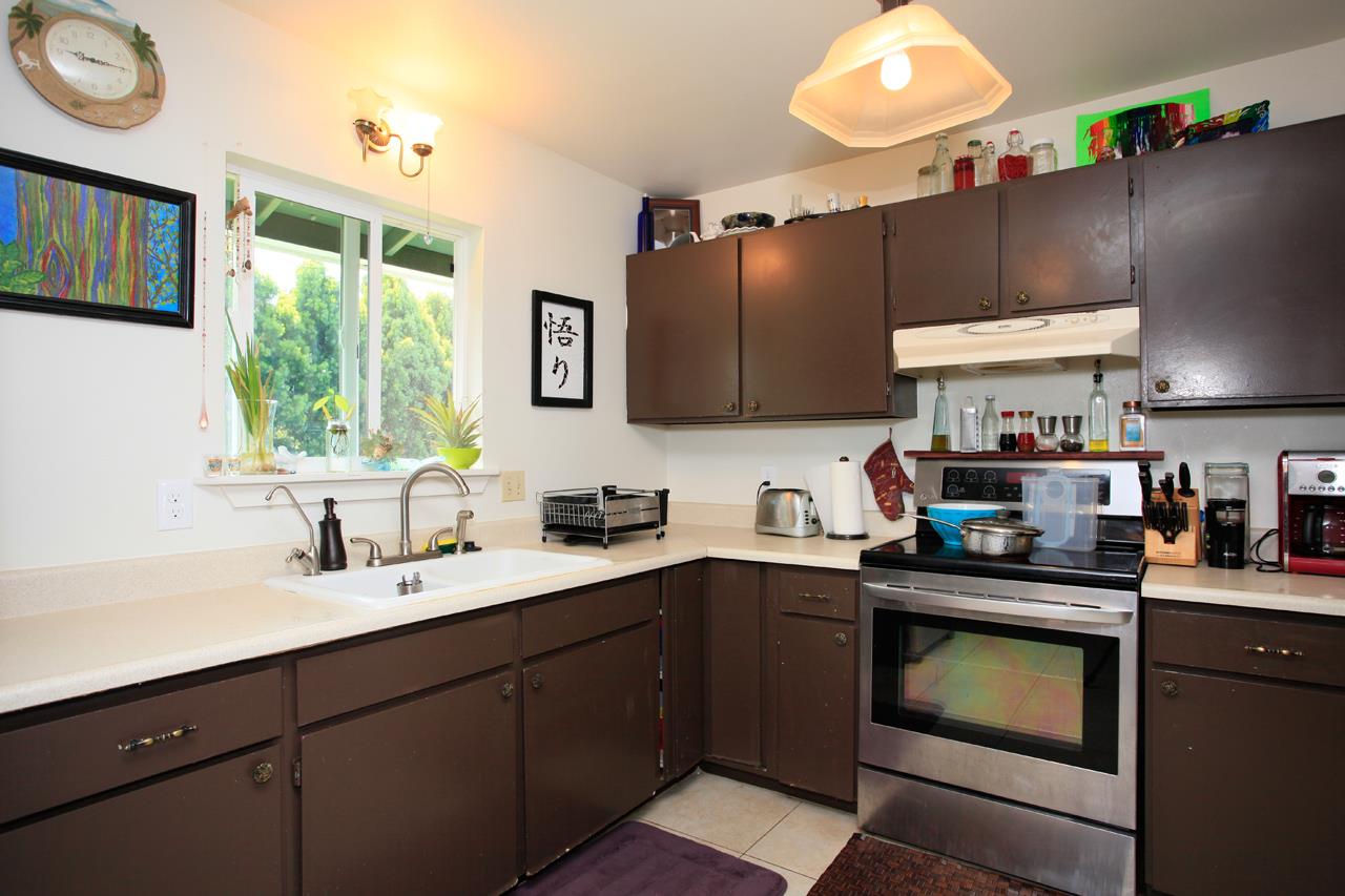 2811 Kokomo Road Haiku, HI 96708 - Photo 6 of 30 a kitchen with a sink cabinets and window